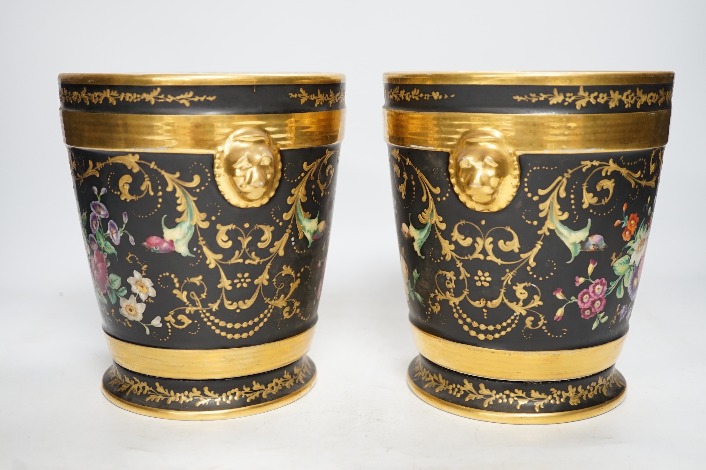 A pair of Paris porcelain cache pots and under dishes, black ground, floral and gilt decoration, 18.5cm high. Condition - both have wear to gilding and black ground, one pot has a star crack to base
